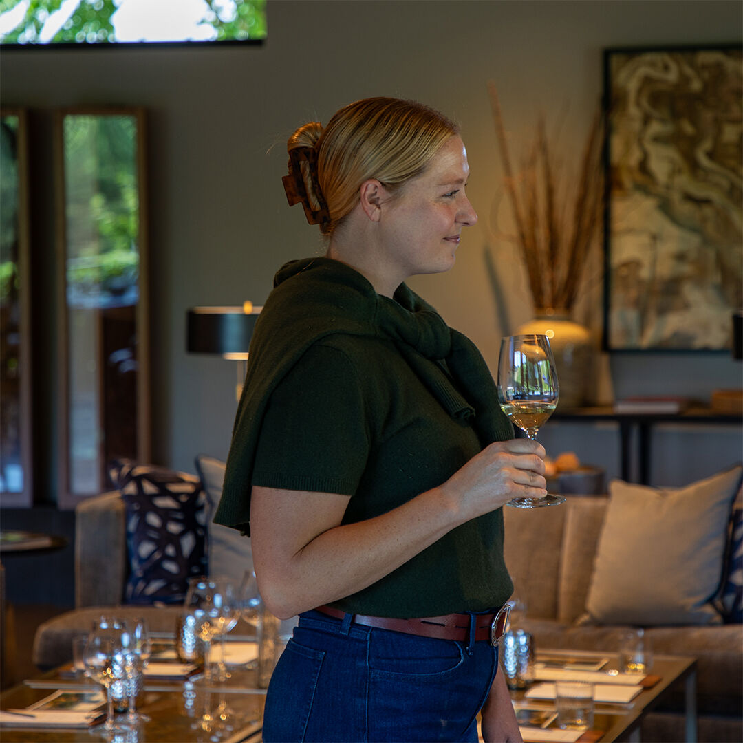 Haley Vachter holding glass of Rosé in WillaKenzie Estate tasting room